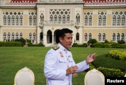 FILE - Thailand's Minister of Digital Economy and Society Chaiwut Thanakamanusorn gestures after a family photo session with new cabinet ministers (not pictured) at the Government House in Bangkok, Thailand, March 30, 2021.
