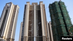 FILE - Residential buildings under construction are seen at Evergrande Cultural Tourism City, a project developed by China Evergrande Group, in Suzhou's Taicang, Jiangsu province, China Sept. 23, 2021. - 