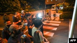 Members of the media wait outside the VIP complex exit of Changi International Airport anticipating the arrival of Sri Lanka's President Gotabaya Rajapaksa, his wife and two bodyguards, in Singapore, July 14, 2022.