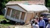 President Joe Biden tours a neighborhood impacted by flooding, Aug. 8, 2022, in Lost Creek, Kentucky. 