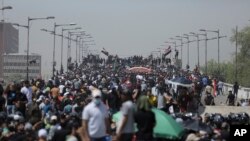 Protesters gather a bridge leading to the Green Zone area in Baghdad, Iraq, Saturday, July 30, 2022 — days after hundreds breached Baghdad's parliament Wednesday chanting anti-Iran curses in a demonstration against a nominee for prime minister by Iran-backed parties.
