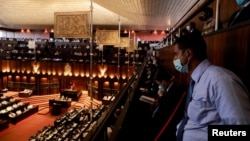 Guests wear protective masks as they attend the presentation of the new government's policy statement during the inaugural session of the new Parliament, in Colombo, Sri Lanka, Aug. 20, 2020. 