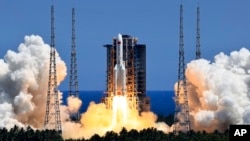 FILE: In this photo released by Xinhua News Agency, the Long March 5B Y3 carrier rocket, carrying Wentian lab module blasts off from the Wenchang Space Launch Center in southern China's Hainan Province, July 24, 2022.
