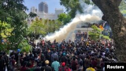 Demonstrators gather outside the office of Sri Lanka's Prime Minister Ranil Wickremesinghe, amid the country's economic crisis, in Colombo, July 13, 2022. 