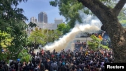 FILE - Demonstrators gather outside the office of Sri Lanka's Prime Minister Ranil Wickremesinghe, amid the country's economic crisis, in Colombo, July 13, 2022. 
