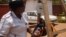 FILE - Charity Salima weighs a child at Achikondi Community Clinic in Lilongwe, Malawi. Malawi's nurses' union wants to allow nurses to work abroad. (Lameck Masina/VOA)