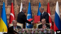 Turkish President Recep Tayyip Erdogan, right, and U.N. Secretary General Antonio Guterres lead a signing ceremony at Dolmabahce Palace in Istanbul, Turkey, Friday, July 22, 2022.