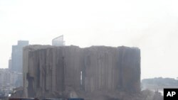 Part of Beirut's massive grain silos, shredded in the 2020 port blast, collapses after a weekslong fire in Beirut, Lebanon, July 31, 2022.