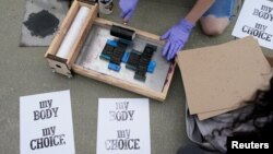FILE - An activist makes signs during a protest outside the U.S. Supreme Court on May 3, 2022 preparing for the overturn of Roe v. Wade abortion rights decision. (REUTERS/Elizabeth Frantz)