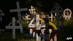 FILE - This photograph taken on July 23, 2022, shows crosses marking graves at the Ermineskin Cemetery near the site of the Ermineskin Residential School in Maskwacis, Alberta, July 23, 2022.