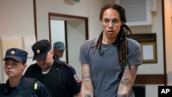 FILE - American basketball player Brittney Griner is escorted before a court hearing outside Moscow, Russia, Aug. 4, 2022.