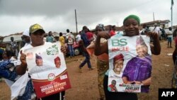 Supporters hold posters to celebrate the victory of opposition candidate Ademola Adeleke, following the conclusion of state gubernatorial elections, in Ido Oshun, Osun state, in southwest Nigeria, July 17, 2022.