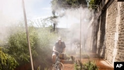 A cyclist cools off at a mist machine as temperature rose up to 39 degrees Celsius, July 13, 2022 in Paris.