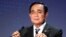 FILE - Thailand's Prime Minister Prayuth Chan-ocha adjusts microphones at a conference in Tokyo on May 26, 2022.