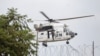 A United Nations Organization Stabilization Mission in the Democratic Republic of the Congo (MONUSCO) peacekeeper rides on a helicopter above the compound of U.N. peacekeeping force's warehouse in Goma in the North Kivu province of the Democratic Republic