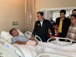 Thailand's Prime Minister Prayuth Chan-ocha visits an injured man in a hospital following a gun battle involving a Thai soldier on a shooting rampage, in Nakhon Ratchasima, Thailand, Feb. 9, 2020.