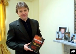 FILE - Alexander Litvinenko, former KGB spy and author of the book "Blowing Up Russia: Terror From Within," is photographed at his home in London, May 10, 2002.