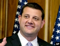 FILE - U.S. Rep. David Valadao, R-Calif., poses during a ceremonial re-enactment of his swearing-in ceremony in the Rayburn Room on Capitol Hill in Washington, Jan. 6, 2015.