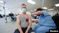 FILE - A man receives a monkeypox vaccination at a clinic run by CIUSSS public health authorities in Montreal, Quebec, June 6, 2022.