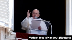 FILE - Pope Francis leads Angelus prayer from his window at the Vatican, June 12, 2022. 