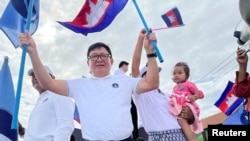 FILE - Vice President of Candlelight Party, Son Chhay, waves flags during a campaign rally for the upcoming local elections on June 5, in Phnom Penh, Cambodia May 21, 2022. Picture taken on May 21, 2022. (REUTERS/Lach Chantha)