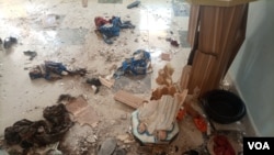 Pieces of clothes, shoes and other items litter the floor at St. Francis Catholic Church in Owo, Nigeria, days after a bloody shooting, June 10, 2022. (Timothy Obiezu/VOA)