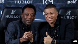 Le Brésilien Pelé, légende du football mondial, à gauche, avec le Français Kylian Mbappé, à Paris, le 2 avril 2019. (AP Photo)