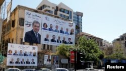 Posters with Lebanese parliament candidates are seen on a building in Beirut, Lebanon, April 23, 2018.