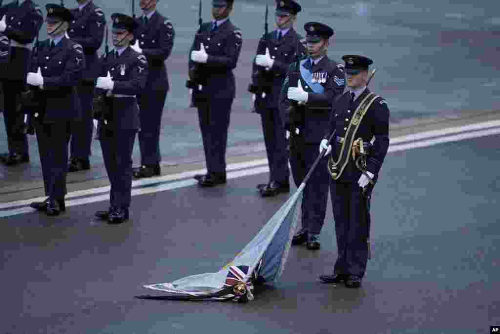 The Kings Colour is lowered as the coffin of Queen Elizabeth II departs RAF Northolt, west London, Sept. 13, 2022, from where it will be taken to Buckingham Palace, London, to lie at rest overnight in the Bow Room.
