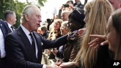 FILE - Britain's King Charles III meets the public near Lambeth Bridge in London, Sept. 17, 2022. Planning for the monarch's coronation next month is being met with subdued enthusiasm in Canada, the Commonwealth's largest country by area.
