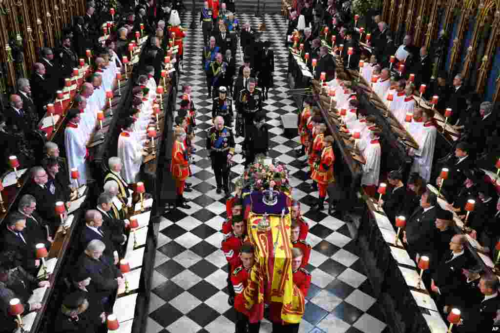 Back to front: Britain&#39;s King Charles III, front left, Camilla, Queen Consort, Princess Anne, Vice Admiral Timothy Laurence, Prince Andrew, Prince Edward, Sophie, Countess of Wessex, Prince William, Prince George Catherine, Princess of Wales, Prince Harry and Meghan, Duchess of Sussex walk behind the coffin of Queen Elizabeth as they leave Westminster Abbey in central London, Sept. 19, 2022.&nbsp;