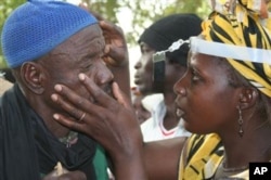 FILE - Residents of a village in Mali are screened for trachoma, a neglected tropical disease and the world’s leading infectious cause of blindness, Jan. 23, 2017. (The Carter Center via AP)