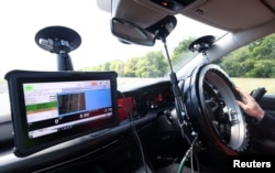 AB Dynamics Application Engineer Hadyn Kiff, gives a demonstration of the Emergency Steering Support (ESS) system. (REUTERS/Matthew Childs)