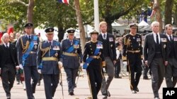From left, the Earl of Snowden, Prince William, King Charles III, the Duke of Gloucester, Princess Anne, Prince Harry, Tim Laurence, Prince Andrew and Peter Phillips follow the coffin of Queen Elizabeth II as it is carried on a horse-drawn gun carriage of