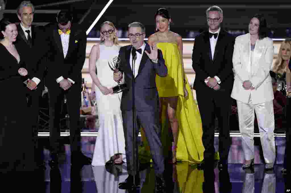 John Oliver, center, and the team from "Last Week Tonight with John Oliver" accepts the Emmy for outstanding variety talk series at the 74th Primetime Emmy Awards at the Microsoft Theater in Los Angeles, Sept. 12, 2022.