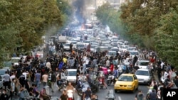 Protesters chant slogans during a protest over the death of a woman who was detained by the morality police, in downtown Tehran, Iran, Sept. 21, 2022, in this photo taken by an individual not employed by the Associated Press and obtained by the AP 