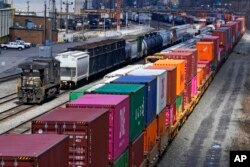 FILE - Freight train cars and containers are seen at Norfolk Southern Railroad's Conway Yard in Conway, Pa., April 2, 2021.