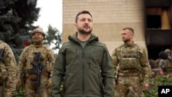 볼로디미르 젤렌스키(가운데) 우크라이나 대통령이 최근 러시아군으로부터 탈환한 하르키우 주 요충지 이지움 시내를 지난 14일 둘러보고 있다. (자료사진)