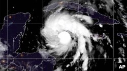 This satellite image provided by the National Oceanic and Atmospheric Administration shows Tropical Storm Ian over the central Caribbean, Sept. 26, 2022. 