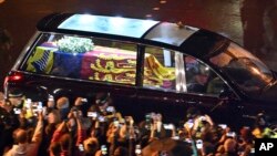 The coffin of Queen Elizabeth in the royal hearse travels to Buckingham Palace in London, Sept. 13, 2022. 