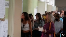 People wait to vote at a polling station in Rome, Italy, Sept. 25, 2022. 
