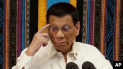 Philippine President Rodrigo Duterte gestures during his 4th State of the Nation Address at the 18th Congress at the House of Representatives in Quezon city, metropolitan Manila, Philippines Monday, July 22, 2019. (AP Photo/Aaron Favila)