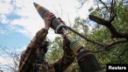 Ukrajinski vojnik puca iz minobacača na liniji fronta u blizini grada Bakhmuta