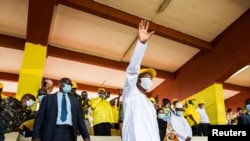 Guinea's outgoing president and presidential candidate Alpha Conde, leader of Rally for the People of Guinea (RPG) waves to supporters as he attends his closing campaign rally ahead of the presidential election in Conakre, Guinea, Oct. 16, 2020.