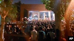 FILE - In this photo taken by an individual not employed by the Associated Press and obtained by the AP outside Iran shows students at a protest over the death of Mahsa Amini, 22, in the custody of the country's morality police, in Tehran, Oct. 7, 2022. 