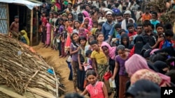 Rohingya Muslims, who from Myanmar into Bangladesh, wait in queues to receive aid at Kutupalong refugee camp in Ukhiya, Bangladesh, Nov. 15, 2017. Secretary of State Rex Tillerson called for an independent investigation into a humanitarian crisis in which