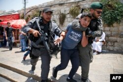 Israeli border guards detain a Palestinian youth during a demonstration outside the Lions Gate, a main entrance to Al-Aqsa mosque compound, due to newly-implemented security measures by Israeli authorities which include metal detectors and cameras, in Jer Israeli border guards detain a Palestinian youth during a demonstration outside the Lions Gate, a main entrance to Al-Aqsa mosque compound, due to newly-implemented security measures by Israeli authorities.
