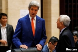 U.S. Secretary of State John Kerry greets Philippine Foreign Secretary Perfecto Yasay as he arrives at a meeting on the sidelines of the ASEAN foreign ministers in Vientiane, Laos July 25, 2016.