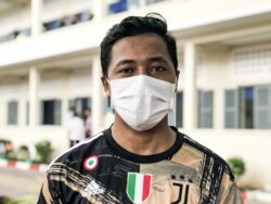 យុវជន លឹម ឡុង អាយុ​២៤​ឆ្នាំ ជា​បុគ្គលិក​នៅ​សណ្ឋាគារ​មួយ​ក្នុង​ទីក្រុងភ្នំពេញ ទើបតែ​ចាក់​វ៉ាក់សាំង​បង្ការ​កូវីដ ដូស​ទី៣ នៅ​សាលា​បឋមសិក្សា​ចៅ​ពញាហុក ក្នុង​សង្កាត់​បឹងកេងកង រាជធានី​ភ្នំពេញ កាលពី​ថ្ងៃ​ទី ១៣ ខែតុលា ឆ្នាំ ២០២១។ (ធីតា វីន/វីអូអេ)