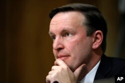 FILE - Sen. Chris Murphy, D-Conn., listens to testimony from Secretary of State-designate Mike Pompeo during a Senate Foreign Relations Committee confirmation hearing on Pompeo's nomination on Capitol Hill in Washington, April 12, 2018.